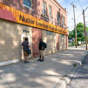 men standing in front of Nutter Ivanhoe Neighborhood Center