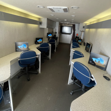 Desks with chairs and computers inside the Goodwill Mobile Workforce unit