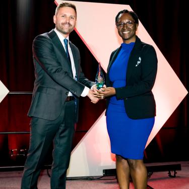 Photo of Fahteema Parrish receiving Small Business Equity Award from Ryan Plemons.