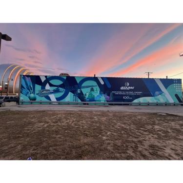 Photo of JE Dunn mural with Kauffman Center for the Performing Arts in the background.
